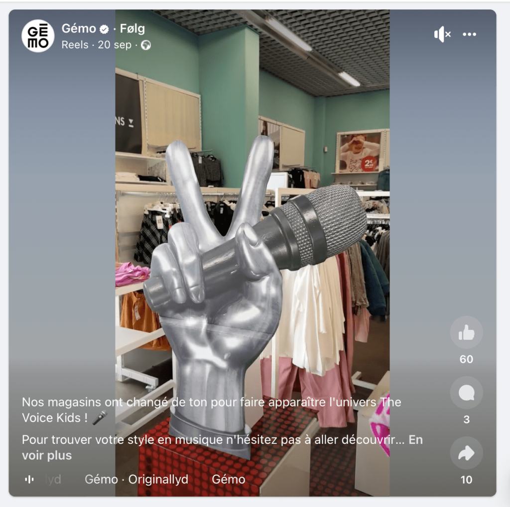 Capture d'écran du compte Instagram de Gémo. Dans cette image on voit le merchandising mis en place pour l'opération notamment la célèbre main The Voice au milieu des vêtements.